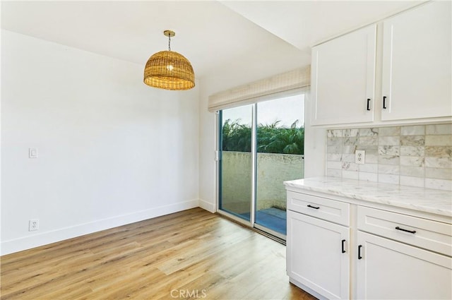 33621 Blue Lantern St, Dana Point, CA 92629 - unfurnished dining area with light wood-style floors and baseboards