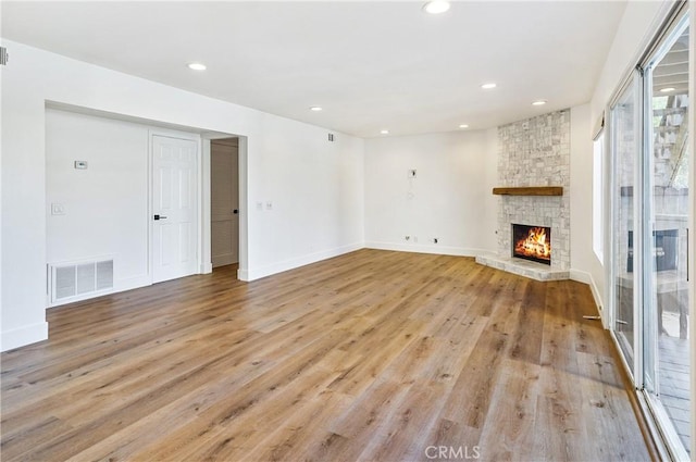 33621 Blue Lantern St, Dana Point, CA 92629 - unfurnished living room with a stone fireplace, light wood-style floors, and recessed lighting