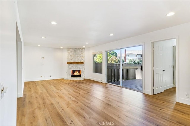 33621 Blue Lantern St, Dana Point, CA 92629 - unfurnished living room with light wood-style flooring, recessed lighting, and a stone fireplace