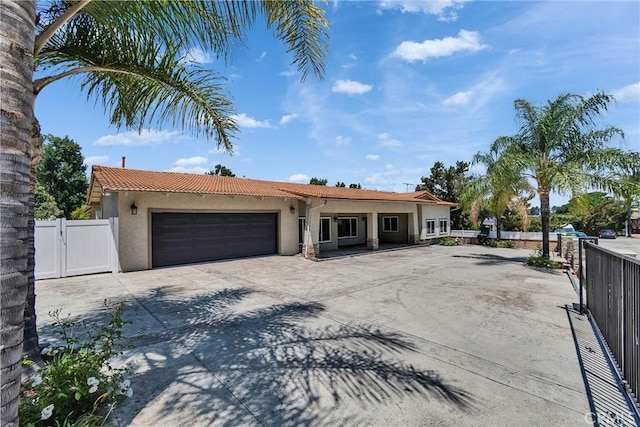 2521 Double Tree Ln, Rowland Heights, CA 91748 - view of front of home featuring a garage, stucco siding, a gate, concrete driveway, and a tile roof