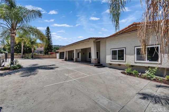 2521 Double Tree Ln, Rowland Heights, CA 91748 - back of property featuring stucco siding, an attached garage, and driveway