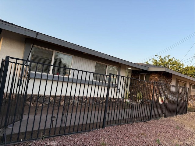 11815 Arliss Way, Grand Terrace, CA 92313 - view of property exterior featuring a fenced front yard and stucco siding