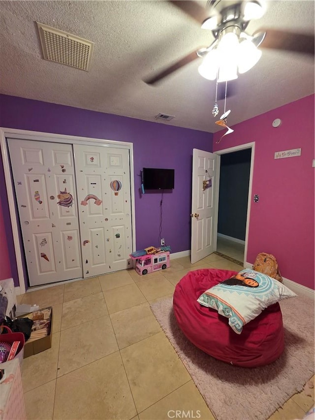 11815 Arliss Way, Grand Terrace, CA 92313 - bedroom with light tile patterned flooring, a closet, a textured ceiling, and ceiling fan