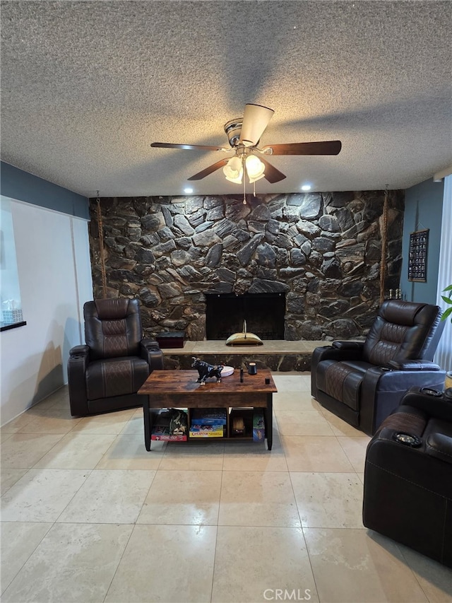 11815 Arliss Way, Grand Terrace, CA 92313 - tiled living area featuring ceiling fan, a textured ceiling, and a fireplace