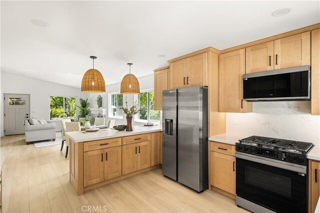 26871 Via Santa Lucia, Mission Viejo, CA 92691 - kitchen featuring black gas stove, stainless steel refrigerator with ice dispenser, a peninsula, and plenty of natural light