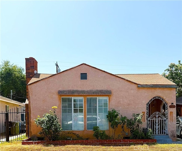 516 N Brand Blvd, San Fernando, CA 91340 - view of home's exterior featuring stucco siding and a chimney