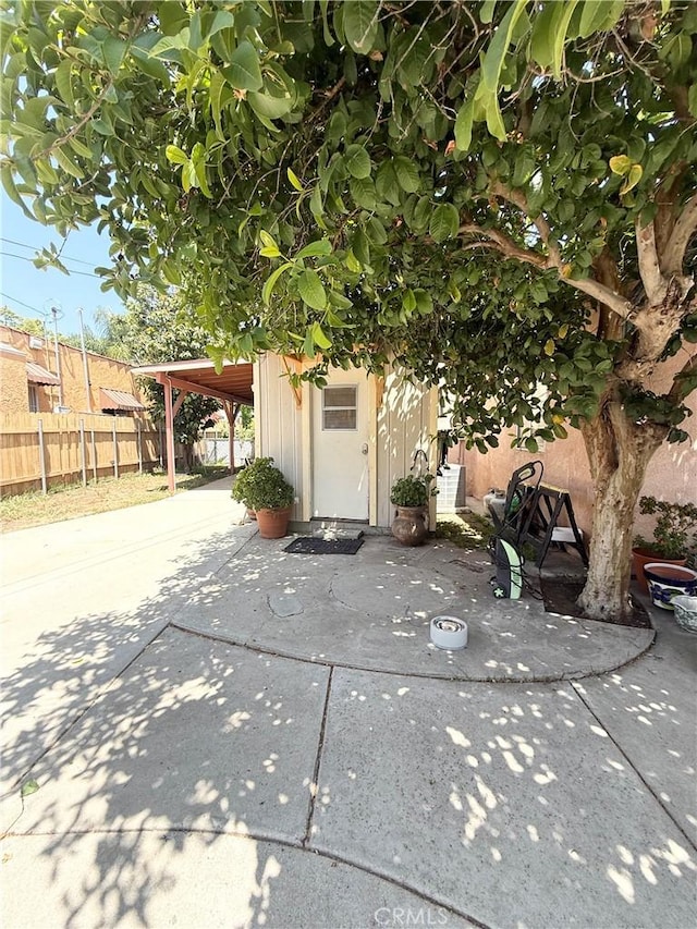 516 N Brand Blvd, San Fernando, CA 91340 - view of property exterior featuring a patio area, driveway, a carport, and an outbuilding