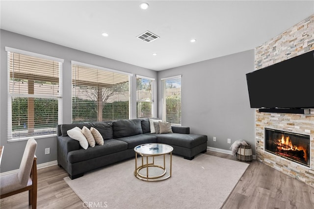 17656 Gladesworth Ln, Canyon Country, CA 91387 - living area featuring light wood-type flooring, a stone fireplace, and recessed lighting