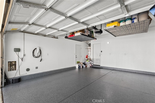 17656 Gladesworth Ln, Canyon Country, CA 91387 - garage with a garage door opener and baseboards