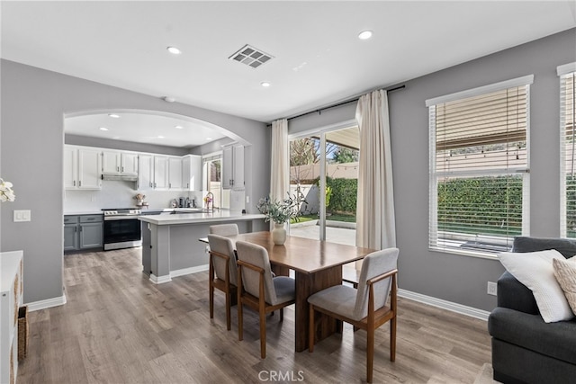 17656 Gladesworth Ln, Canyon Country, CA 91387 - dining room featuring arched walkways, light wood finished floors, and recessed lighting