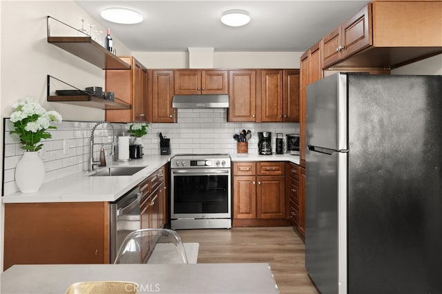 341 Carriage Dr Unit 51-A, Santa Ana, CA 92707 - kitchen featuring appliances with stainless steel finishes, open shelves, extractor fan, light countertops, and decorative backsplash