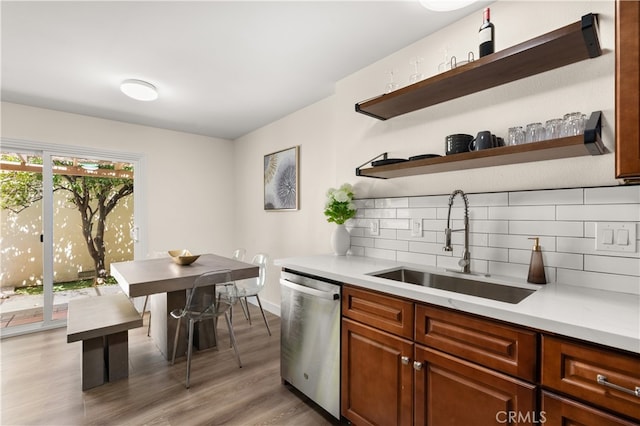 341 Carriage Dr Unit 51-A, Santa Ana, CA 92707 - kitchen featuring dishwasher, decorative backsplash, light countertops, and light wood-style flooring