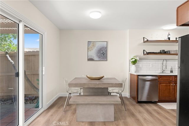 341 Carriage Dr Unit 51-A, Santa Ana, CA 92707 - dining area featuring light wood-style flooring and bar area