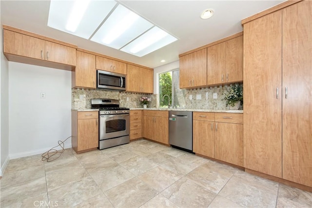 120 Rue Monet, Lake Forest, CA 92610 - kitchen featuring appliances with stainless steel finishes, backsplash, and light stone countertops