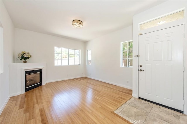 120 Rue Monet, Lake Forest, CA 92610 - foyer entrance with healthy amount of natural light, light wood-type flooring, and a glass covered fireplace