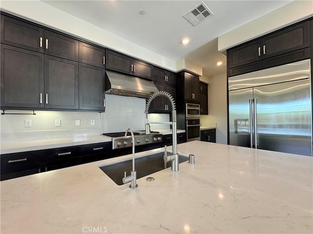 325 Sawbuck, Irvine, CA 92618 - kitchen with stainless steel appliances, under cabinet range hood, light stone countertops, and recessed lighting