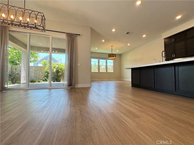 325 Sawbuck, Irvine, CA 92618 - unfurnished living room featuring a chandelier, light wood-style floors, and recessed lighting