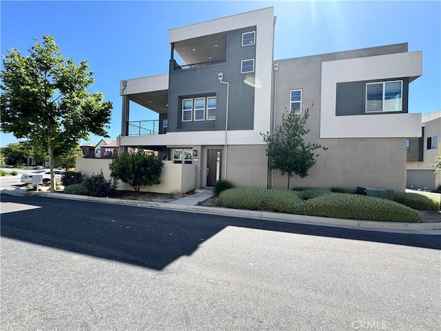 325 Sawbuck, Irvine, CA 92618 - modern home featuring stucco siding and a balcony