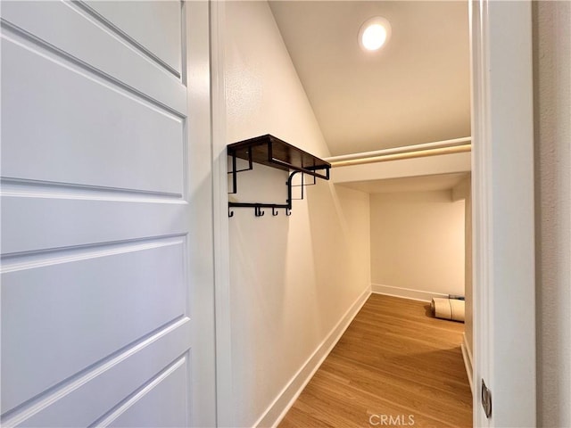 325 Sawbuck, Irvine, CA 92618 - walk in closet featuring lofted ceiling and wood finished floors