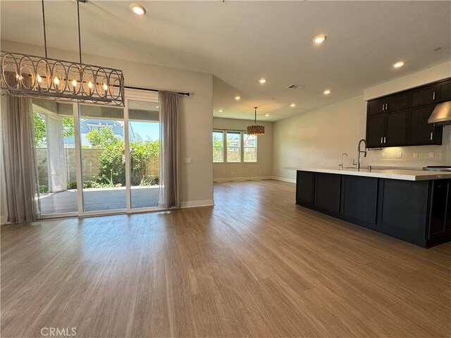 325 Sawbuck, Irvine, CA 92618 - kitchen with a chandelier, light countertops, open floor plan, light wood-style floors, and recessed lighting