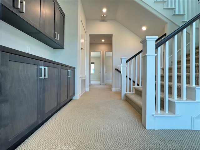 325 Sawbuck, Irvine, CA 92618 - hall with light colored carpet, stairs, vaulted ceiling, and recessed lighting