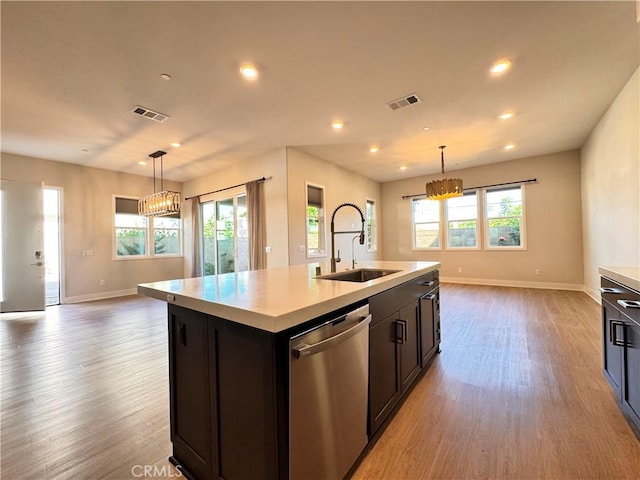 325 Sawbuck, Irvine, CA 92618 - kitchen featuring stainless steel dishwasher, a chandelier, light wood-style flooring, light countertops, and open floor plan