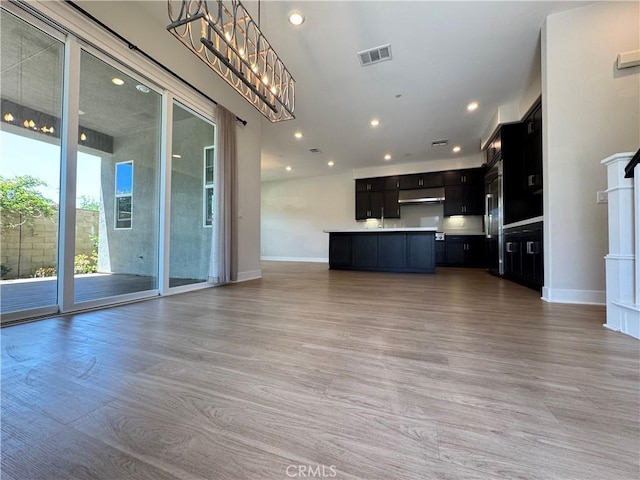 325 Sawbuck, Irvine, CA 92618 - unfurnished living room featuring recessed lighting, light wood finished floors, and a chandelier