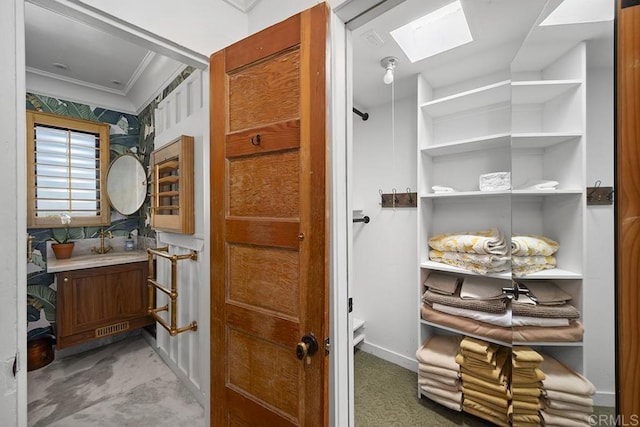 1683 Linwood St, San Diego, CA 92103 - bathroom with ornamental molding, vanity, and a skylight