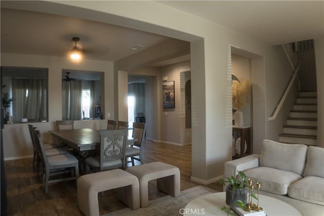 8851 Montclair Ave, Hesperia, CA 92344 - dining area featuring wood finished floors, ceiling fan, stairway, and arched walkways