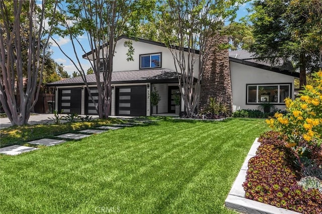 772 N Malden Ave, Fullerton, CA 92832 - rear view of property featuring stucco siding, a lawn, and a chimney