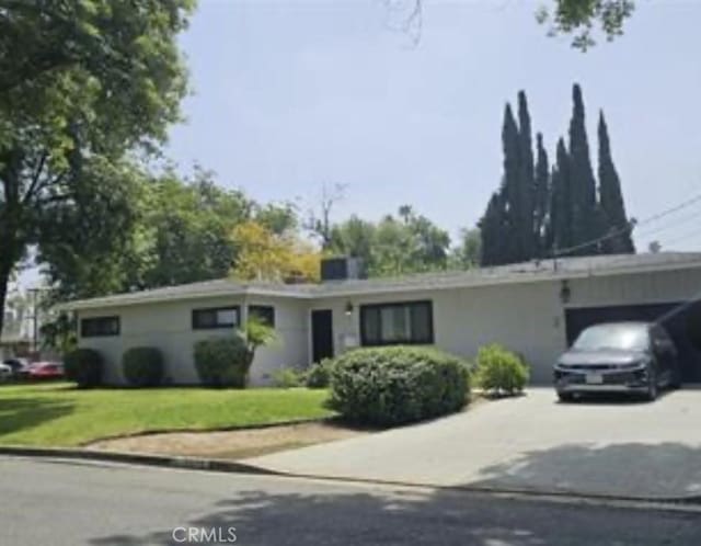 7272 Mount Vernon St, Riverside, CA 92504 - ranch-style house with driveway, a carport, and a front yard