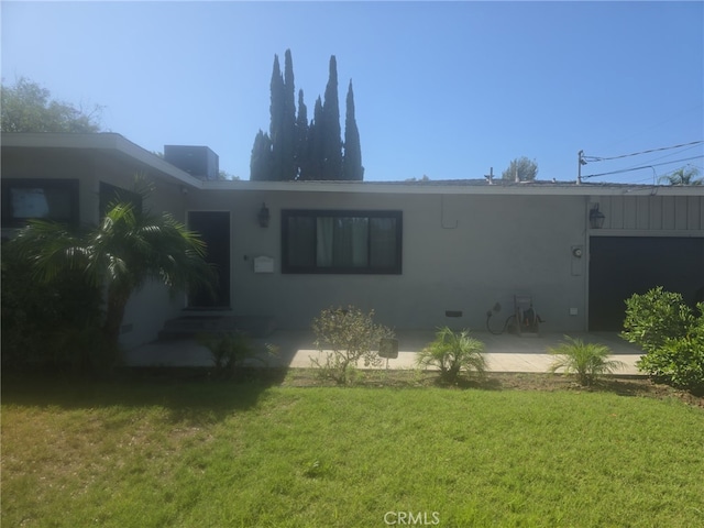 7272 Mount Vernon St, Riverside, CA 92504 - back of property with a lawn, stucco siding, and a patio