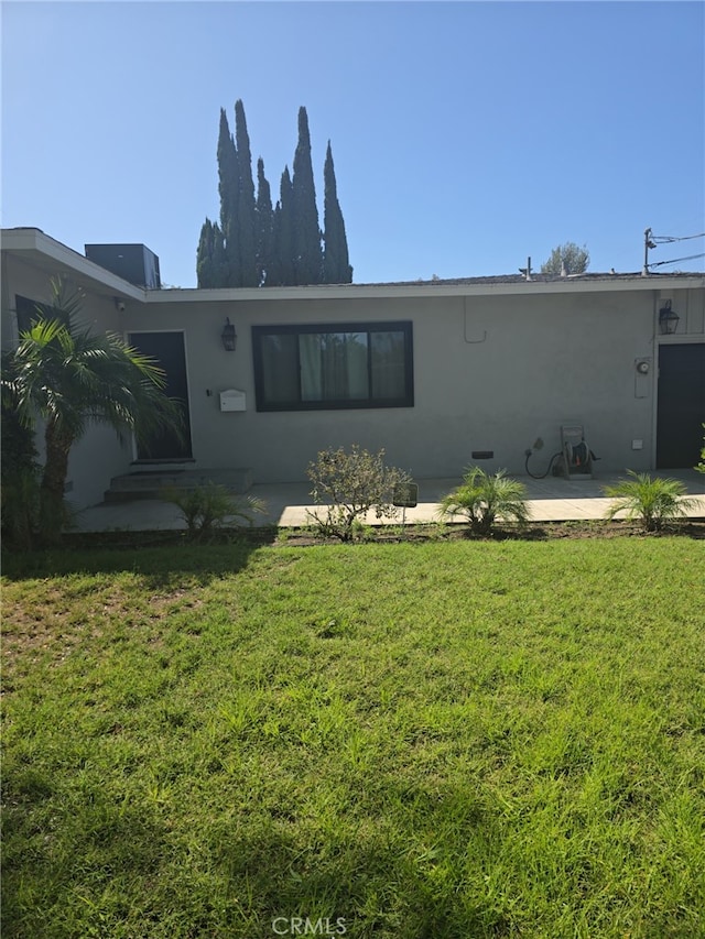 7272 Mount Vernon St, Riverside, CA 92504 - rear view of house featuring stucco siding, a yard, and a patio