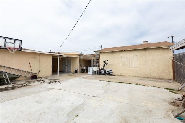 2820 S M St, Oxnard, CA 93033 - rear view of house with stucco siding, a chimney, and a patio area