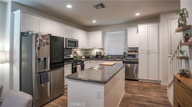 7600 Channel View St, Chino, CA 91708 - kitchen featuring appliances with stainless steel finishes, white cabinets, dark wood-style floors, recessed lighting, and dark stone counters