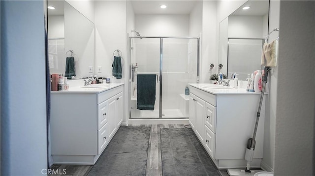 7600 Channel View St, Chino, CA 91708 - bathroom with a stall shower, two vanities, recessed lighting, and wood finished floors