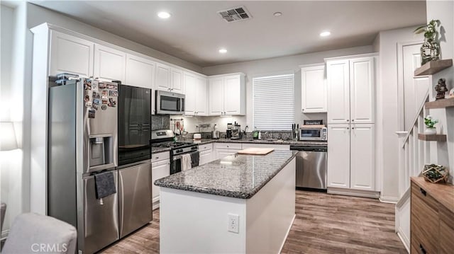 7600 Channel View St, Chino, CA 91708 - kitchen featuring stainless steel appliances, white cabinetry, dark stone countertops, wood finished floors, and recessed lighting