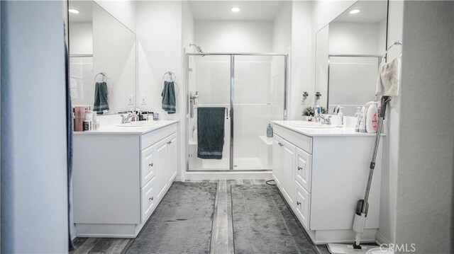 7600 Channel View St, Chino, CA 91708 - bathroom with a stall shower, two vanities, recessed lighting, and wood finished floors