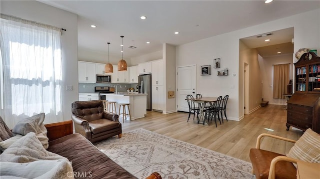 4173 Horvath St Unit 105, Corona, CA 92883 - living area featuring light wood finished floors and recessed lighting