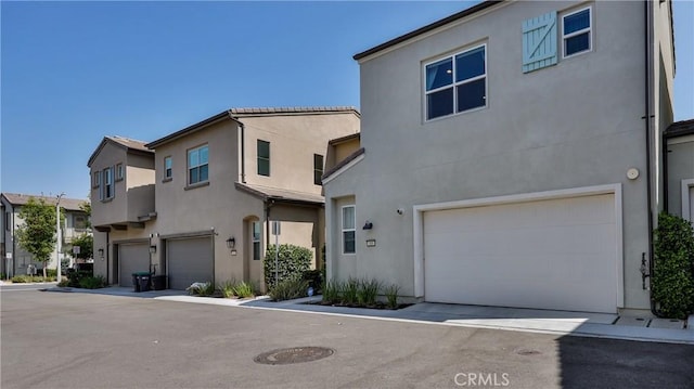 4173 Horvath St Unit 105, Corona, CA 92883 - view of front of home featuring a garage and stucco siding