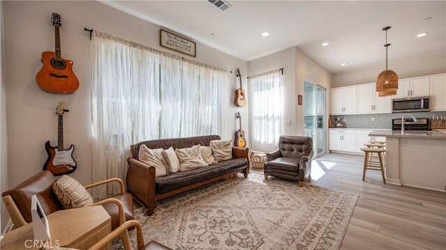 4173 Horvath St Unit 105, Corona, CA 92883 - living room featuring light wood-style floors and recessed lighting