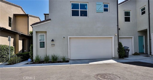 4173 Horvath St Unit 105, Corona, CA 92883 - view of front of home with a garage, stucco siding, and concrete driveway