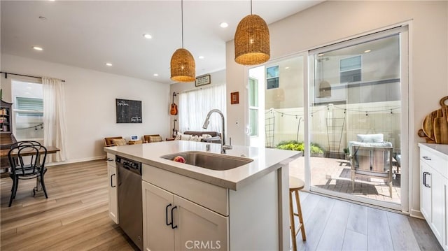 4173 Horvath St Unit 105, Corona, CA 92883 - kitchen with dishwasher, light wood-type flooring, decorative light fixtures, white cabinets, and recessed lighting