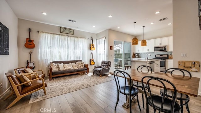 4173 Horvath St Unit 105, Corona, CA 92883 - dining room with light wood-style floors and recessed lighting