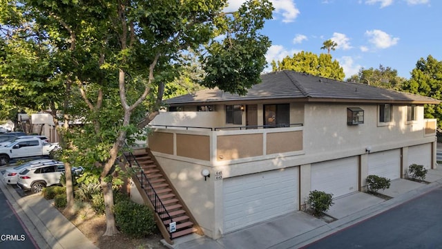 640 Orwell Ln, Ventura, CA 93003 - view of front of home featuring a garage, stairway, stucco siding, and driveway
