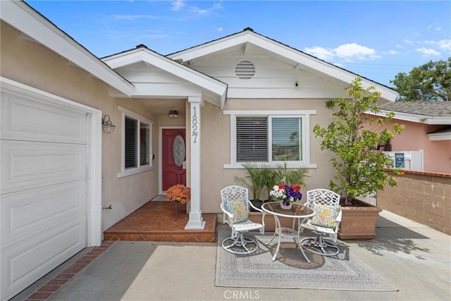 1827 Amelia Ave, San Pedro, CA 90731 - doorway to property featuring an attached garage and stucco siding