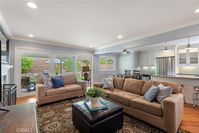 1827 Amelia Ave, San Pedro, CA 90731 - living room featuring plenty of natural light, light wood-type flooring, recessed lighting, crown molding, and ceiling fan