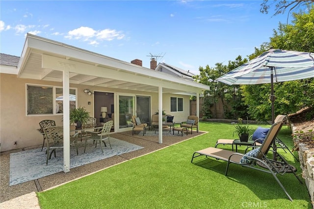 1827 Amelia Ave, San Pedro, CA 90731 - rear view of house featuring stucco siding, a patio area, a lawn, and a chimney
