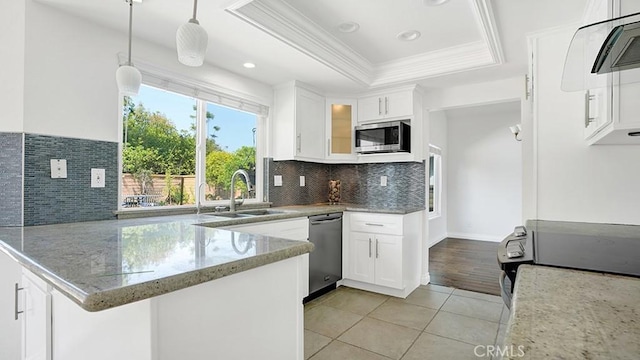 25866 Greenhill, Lake Forest, CA 92630 - kitchen with appliances with stainless steel finishes, a peninsula, a raised ceiling, light stone countertops, and ornamental molding