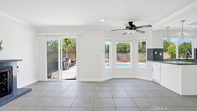 25866 Greenhill, Lake Forest, CA 92630 - unfurnished living room featuring a fireplace with raised hearth, ceiling fan, crown molding, light tile patterned flooring, and recessed lighting